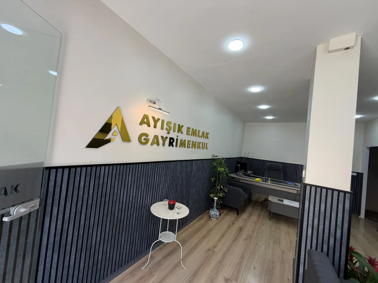 Ayışık Gayrimenkul logosunun bulunduğu ofis karşılama alanı